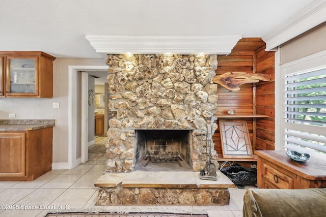 unfurnished living room with baseboards, light tile patterned flooring, and a fireplace