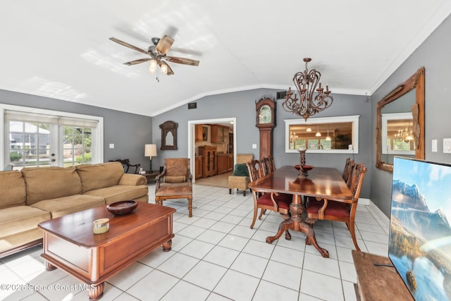 living room with ceiling fan with notable chandelier, light tile patterned floors, ornamental molding, and vaulted ceiling