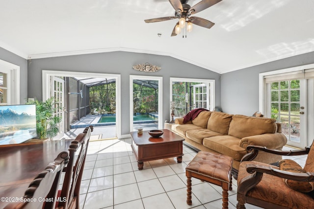 living area with a sunroom, a healthy amount of sunlight, ceiling fan, and light tile patterned flooring