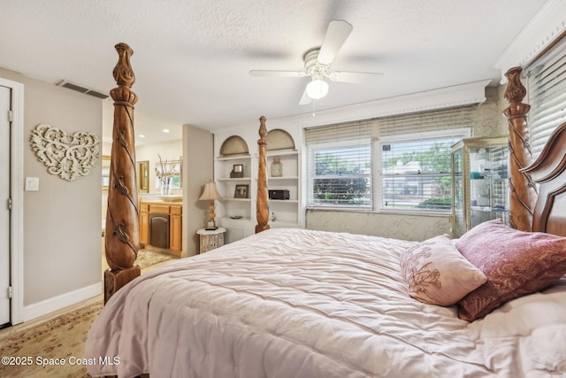 bedroom featuring visible vents, baseboards, a ceiling fan, and a textured ceiling