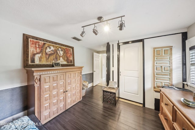 interior space featuring dark wood-style flooring and visible vents