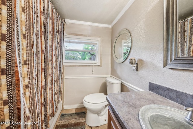 bathroom with crown molding, vanity, a shower with curtain, toilet, and a textured wall