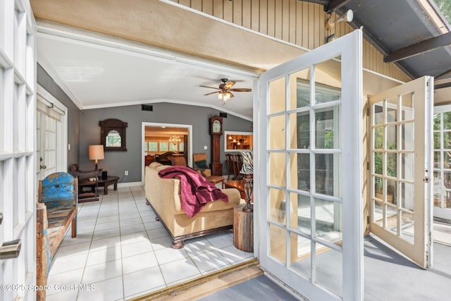 living room with plenty of natural light, light tile patterned floors, a ceiling fan, visible vents, and lofted ceiling