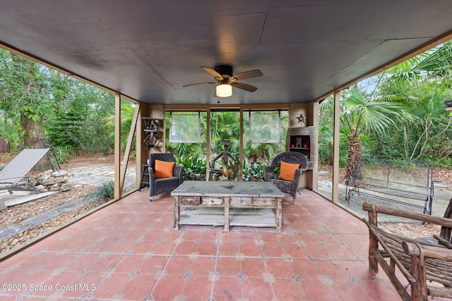 view of patio / terrace featuring a fireplace and ceiling fan