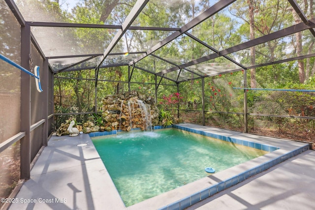 view of pool featuring glass enclosure