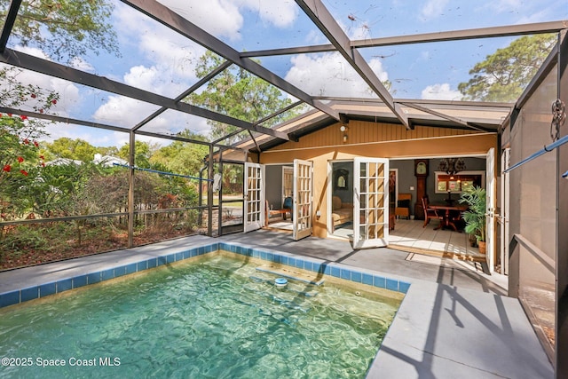 view of swimming pool featuring a patio area, a lanai, and a hot tub