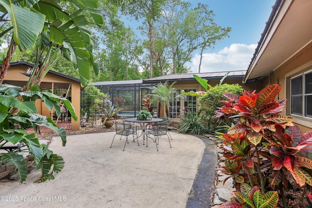 view of patio with glass enclosure