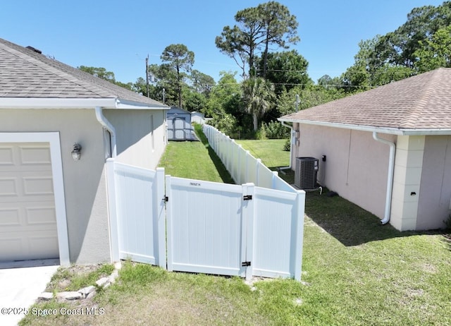 2507 Peralta Dr, Palm Bay, FL 32909 - view of side of home with a fenced backyard, stucco siding, a lawn, roof with shingles, and a gate