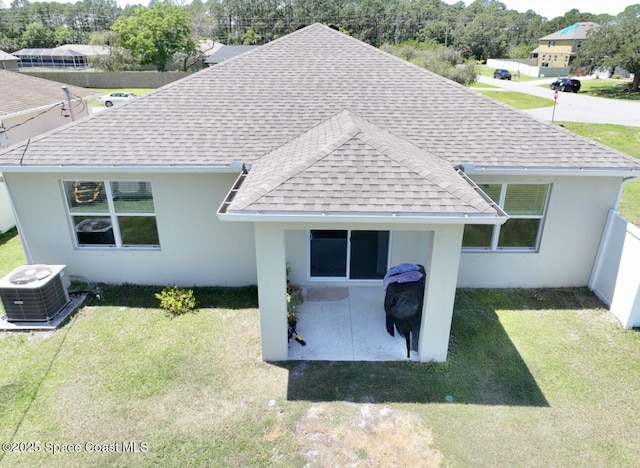 2507 Peralta Dr, Palm Bay, FL 32909 - exterior space with central air condition unit, stucco siding, a patio, a front yard, and a shingled roof