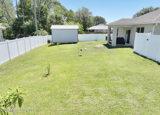 2507 Peralta Dr, Palm Bay, FL 32909 - view of yard featuring a fenced backyard, an outdoor structure, and a storage unit
