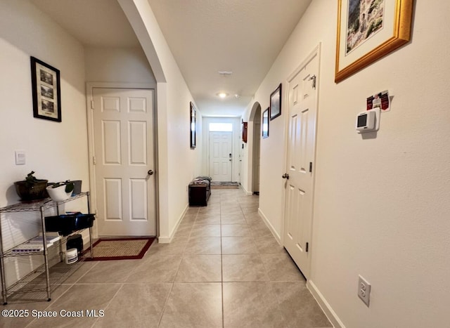 2507 Peralta Dr, Palm Bay, FL 32909 - corridor with light tile patterned floors, baseboards, and arched walkways