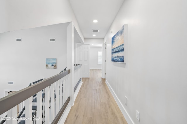 6765 Angeles Rd, Melbourne Beach, FL 32951 - corridor featuring an upstairs landing, light wood-style flooring, recessed lighting, and baseboards
