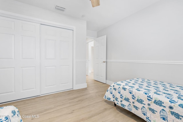 6765 Angeles Rd, Melbourne Beach, FL 32951 - bedroom with light wood-style floors, a closet, baseboards, and ceiling fan