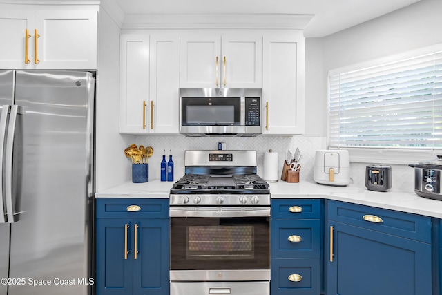 6765 Angeles Rd, Melbourne Beach, FL 32951 - kitchen with appliances with stainless steel finishes, blue cabinetry, and white cabinets