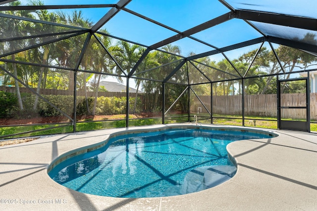 6765 Angeles Rd, Melbourne Beach, FL 32951 - outdoor pool with a patio, a fenced backyard, and glass enclosure