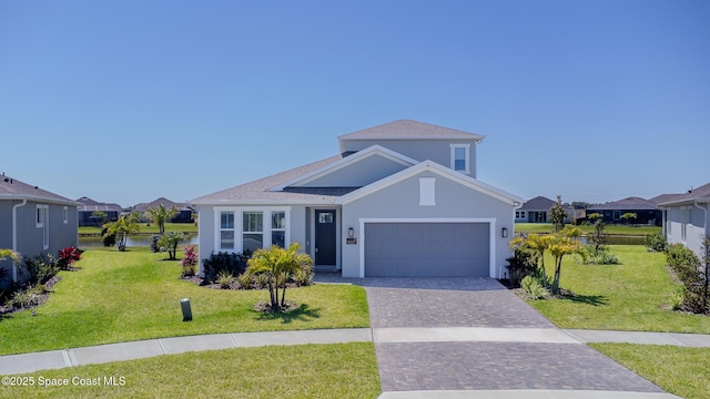 9527 Ebeko Ct, Melbourne, FL 32940 - view of front of home featuring an attached garage, stucco siding, a front yard, decorative driveway, and a residential view