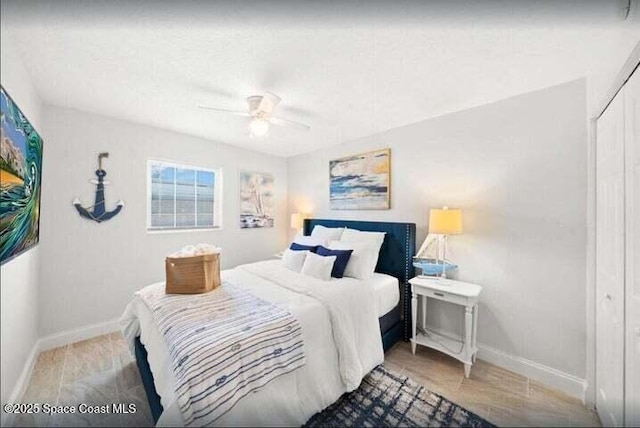 bedroom featuring a closet, baseboards, and a ceiling fan