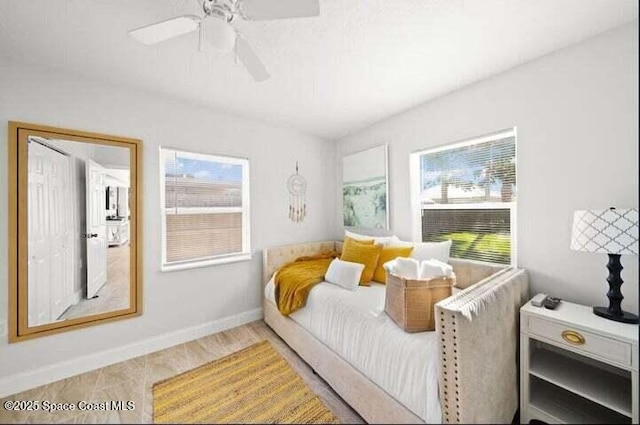 bedroom featuring ceiling fan and baseboards