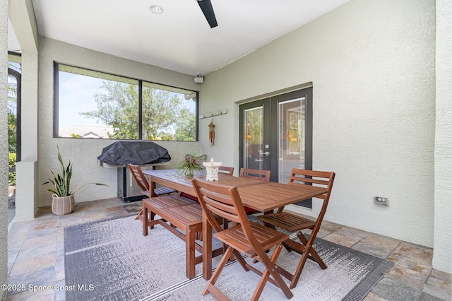897 Yellow Wood Ct SE, Palm Bay, FL 32909 - dining room with french doors, a textured wall, ceiling fan, and stone tile flooring