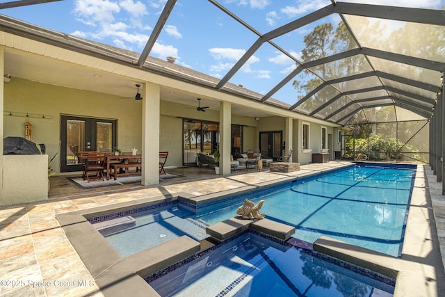 897 Yellow Wood Ct SE, Palm Bay, FL 32909 - view of swimming pool featuring a patio area, a pool with connected hot tub, a ceiling fan, glass enclosure, and french doors