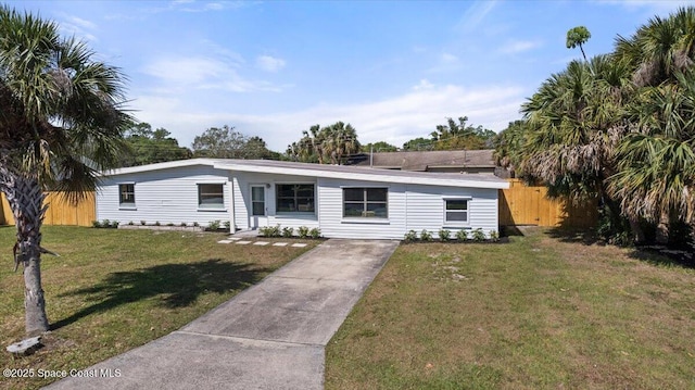 1800 Elmwood Dr, Melbourne, FL 32935 - view of front of home featuring driveway, a front yard, and fence