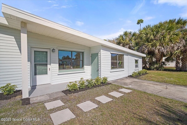 1800 Elmwood Dr, Melbourne, FL 32935 - doorway to property with a yard
