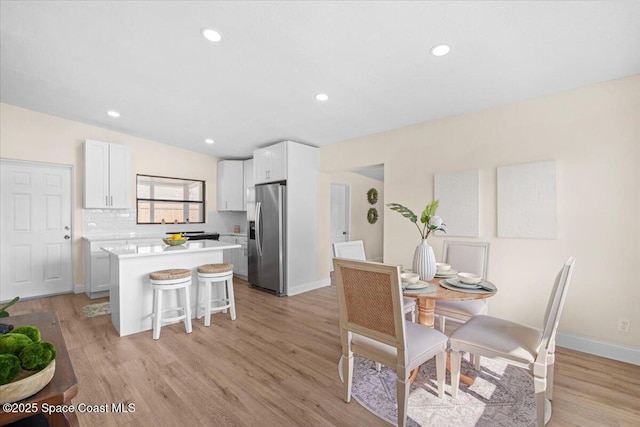 1800 Elmwood Dr, Melbourne, FL 32935 - dining room with baseboards, light wood-type flooring, and recessed lighting