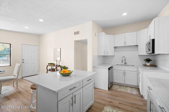 1800 Elmwood Dr, Melbourne, FL 32935 - kitchen with a sink, visible vents, backsplash, and appliances with stainless steel finishes