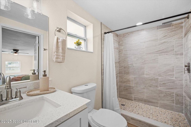 1800 Elmwood Dr, Melbourne, FL 32935 - full bathroom with vanity, a tile shower, toilet, and ceiling fan