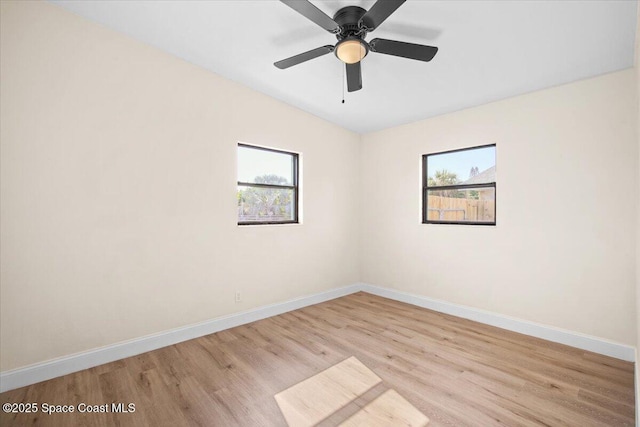 1800 Elmwood Dr, Melbourne, FL 32935 - empty room with baseboards, a ceiling fan, plenty of natural light, and light wood-style floors