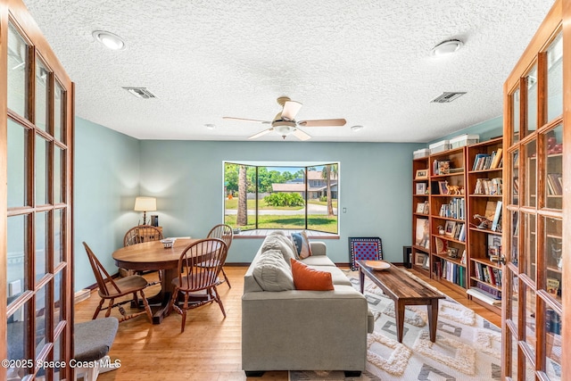 1475 S Oaks Dr, Merritt Island, FL 32952 - sitting room with baseboards, wood finished floors, visible vents, and ceiling fan