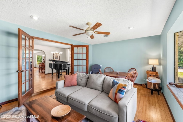 1475 S Oaks Dr, Merritt Island, FL 32952 - living room featuring french doors, a textured ceiling, and light wood-style flooring