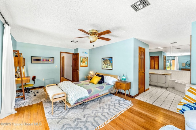 1475 S Oaks Dr, Merritt Island, FL 32952 - bedroom featuring baseboards, wood finished floors, and visible vents