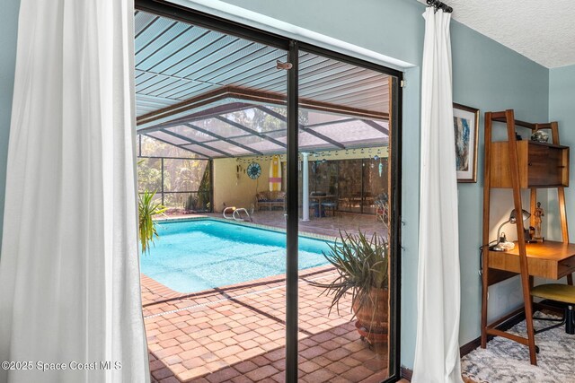 1475 S Oaks Dr, Merritt Island, FL 32952 - outdoor pool featuring glass enclosure and a patio