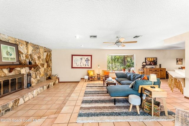 1475 S Oaks Dr, Merritt Island, FL 32952 - living room featuring a ceiling fan, visible vents, a textured ceiling, and light tile patterned floors