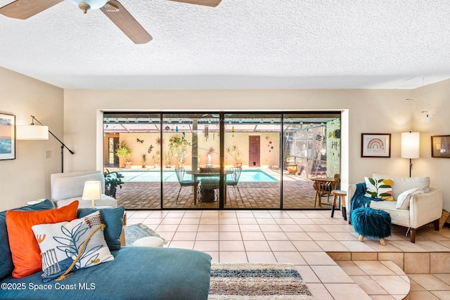 1475 S Oaks Dr, Merritt Island, FL 32952 - living area with tile patterned floors, a ceiling fan, and a textured ceiling