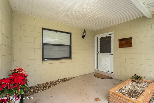 100 Barbados Dr, Merritt Island, FL 32952 - entrance to property featuring concrete block siding