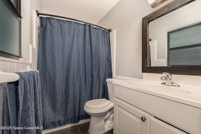 100 Barbados Dr, Merritt Island, FL 32952 - bathroom featuring vanity, toilet, a shower with curtain, and tile patterned flooring