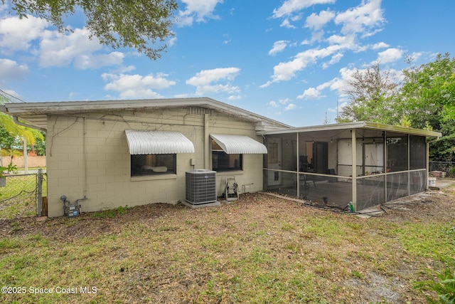 100 Barbados Dr, Merritt Island, FL 32952 - back of house featuring fence, a yard, central air condition unit, concrete block siding, and a sunroom