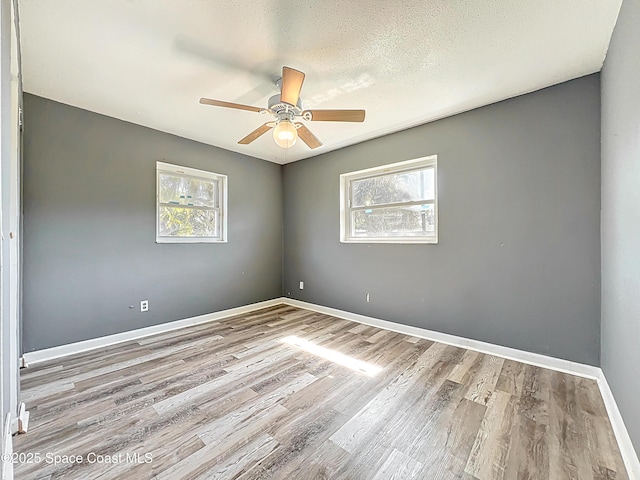 2543 Hathaway Dr, Cocoa, FL 32926 - spare room with plenty of natural light, wood finished floors, a ceiling fan, and baseboards