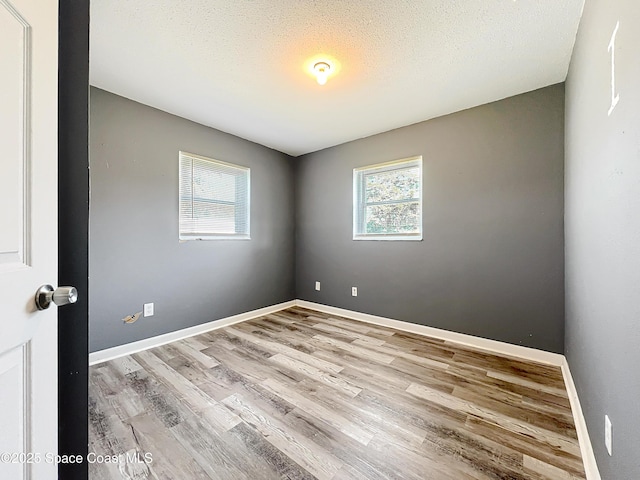 2543 Hathaway Dr, Cocoa, FL 32926 - unfurnished room featuring wood finished floors, baseboards, and a textured ceiling