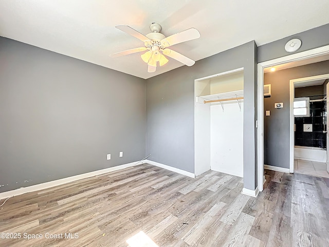 2543 Hathaway Dr, Cocoa, FL 32926 - unfurnished bedroom featuring wood finished floors, a closet, baseboards, and ceiling fan