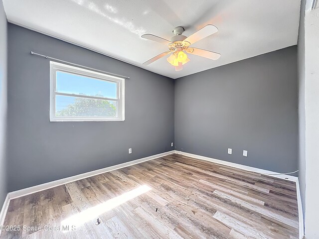 2543 Hathaway Dr, Cocoa, FL 32926 - unfurnished room with wood finished floors, a ceiling fan, and baseboards