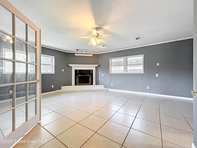2543 Hathaway Dr, Cocoa, FL 32926 - unfurnished living room with a ceiling fan, light tile patterned floors, a fireplace with raised hearth, and baseboards