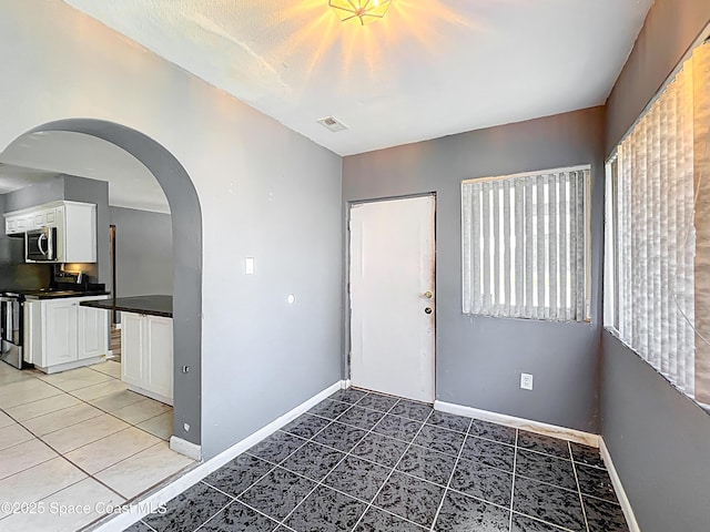 2543 Hathaway Dr, Cocoa, FL 32926 - entryway featuring arched walkways, baseboards, and light tile patterned flooring