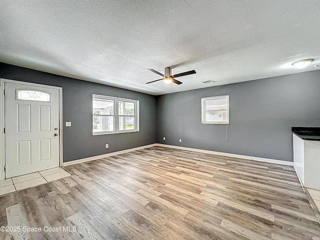 2543 Hathaway Dr, Cocoa, FL 32926 - entryway with wood finished floors, a textured ceiling, a ceiling fan, and baseboards