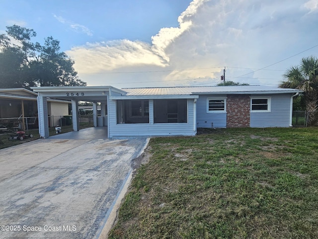 2543 Hathaway Dr, Cocoa, FL 32926 - rear view of house featuring driveway, a carport, and metal roof