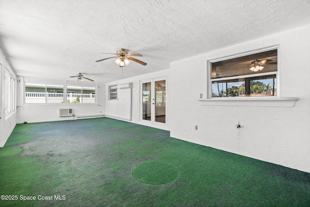 unfurnished sunroom featuring plenty of natural light, a wall unit AC, and an AC wall unit