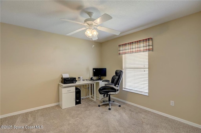 office area featuring baseboards, a ceiling fan, light carpet, and a textured ceiling