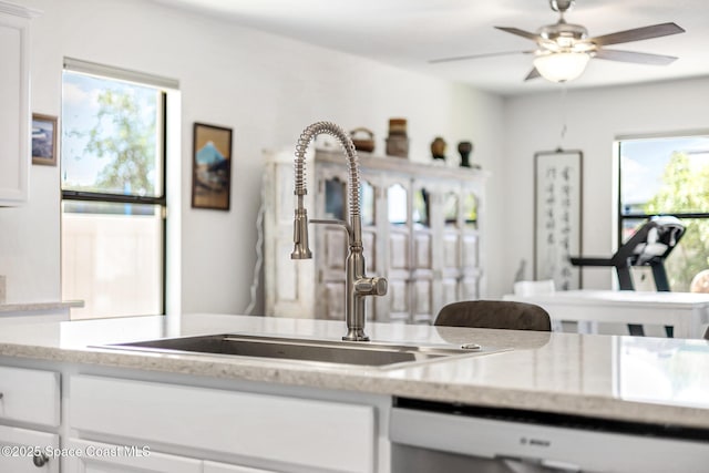 413 Catfish Pl, Cocoa, FL 32927 - kitchen featuring plenty of natural light, a sink, dishwashing machine, and white cabinetry